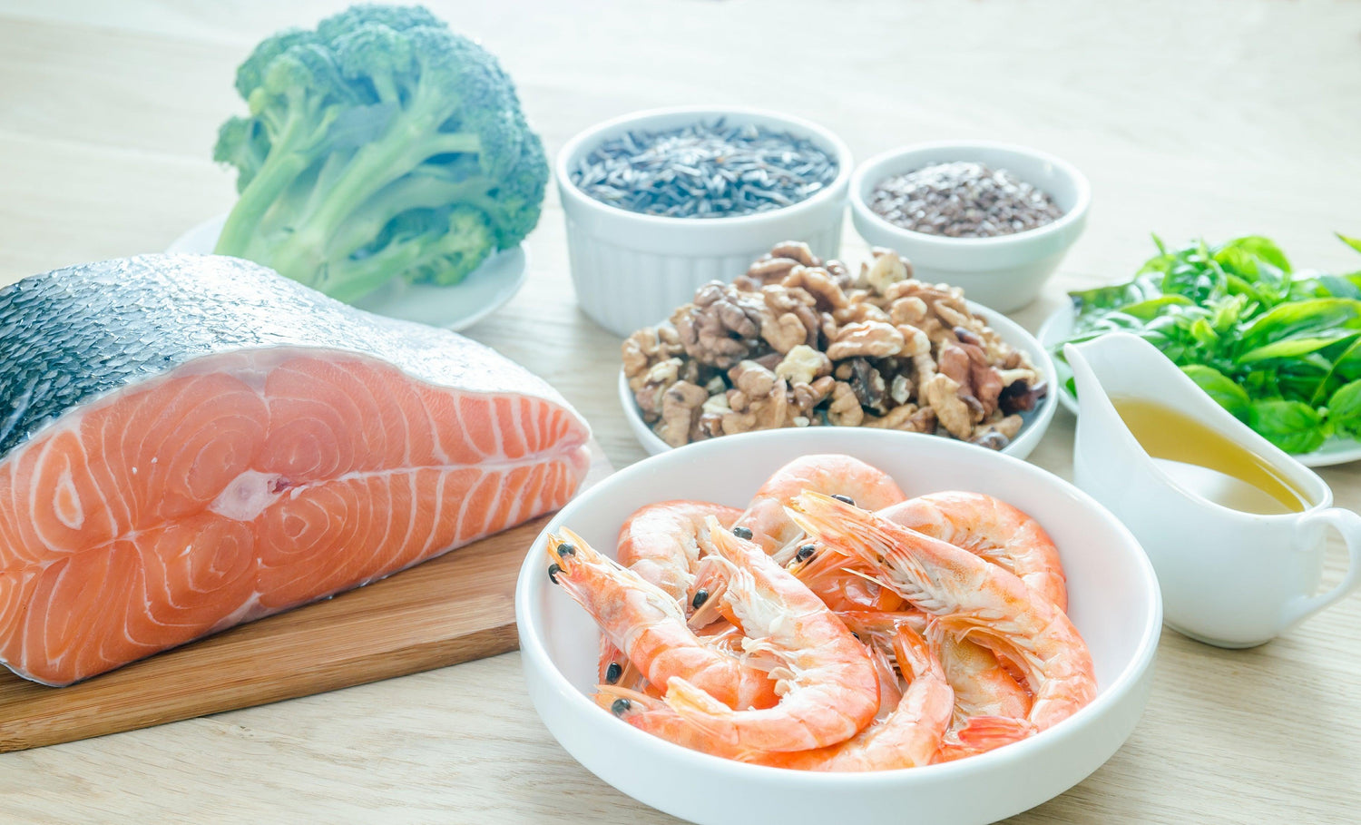 Assorted omega-3 rich foods including salmon, shrimp, walnuts, broccoli, flaxseeds, wild rice, and a jug of oil, displayed on a wooden surface.