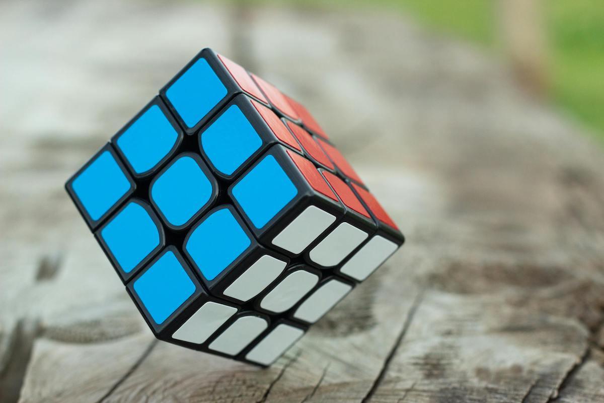 Partially solved Rubik's Cube resting on a wooden surface, symbolizing problem-solving and mental focus.