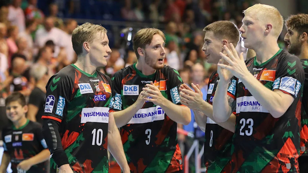 SC Magdeburg handball players in action during a match — team unity, Bundesliga performance, and professional handball in Germany
