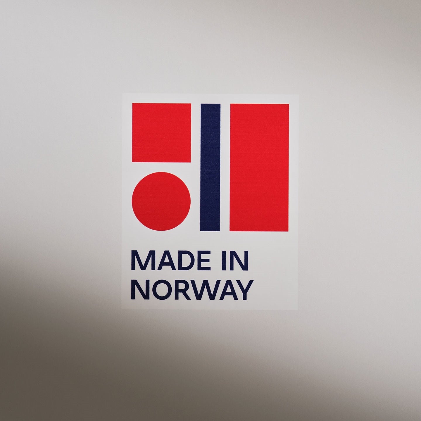 Official “Made in Norway” label featuring a bold red and blue geometric design and text indicating Norwegian origin.