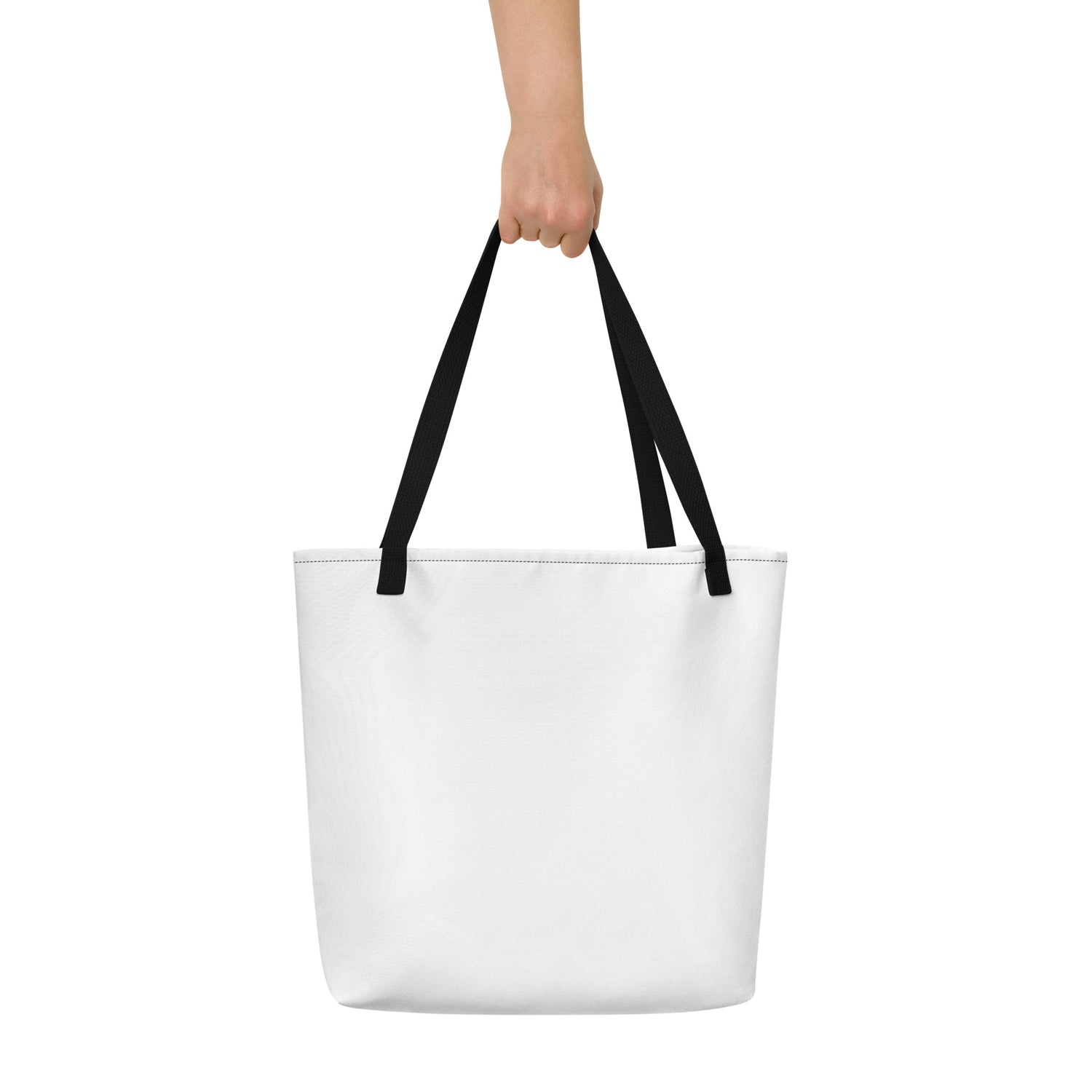 Minimalist white tote bag with black handles, held up by a hand against a plain white background.