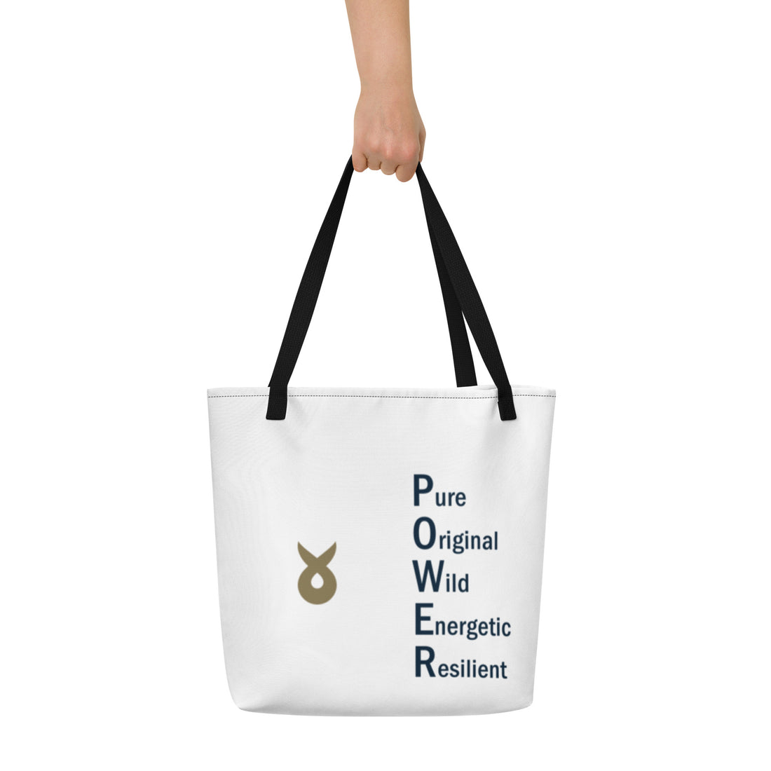 White tote bag with black handles, featuring the word "POWER" written vertically as an acronym (Pure, Original, Wild, Energetic, Resilient) and a gold Ballstad logo beside the text, held by a hand against a plain white background.