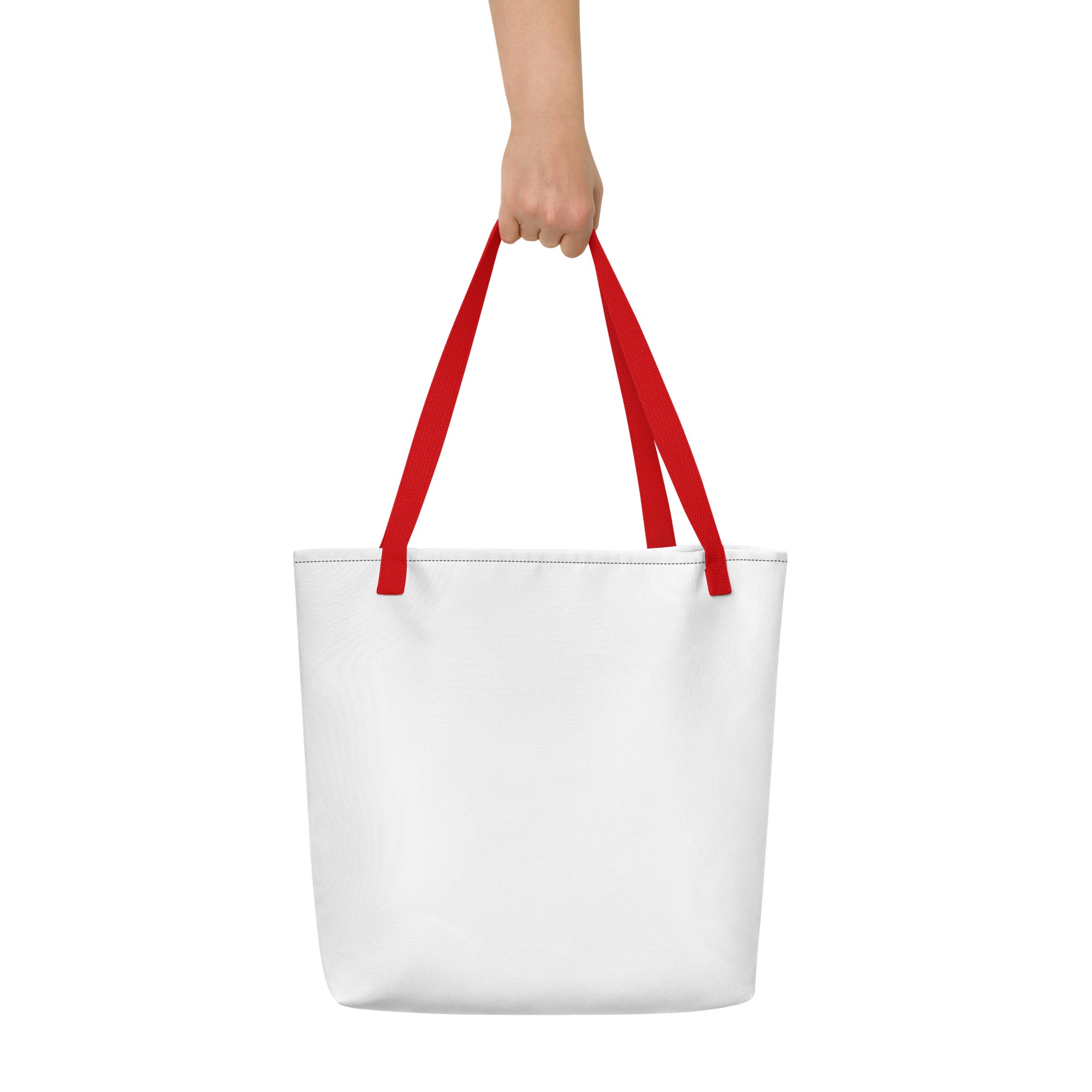 Minimalist white tote bag with bright red handles, held up by a hand against a plain white background.