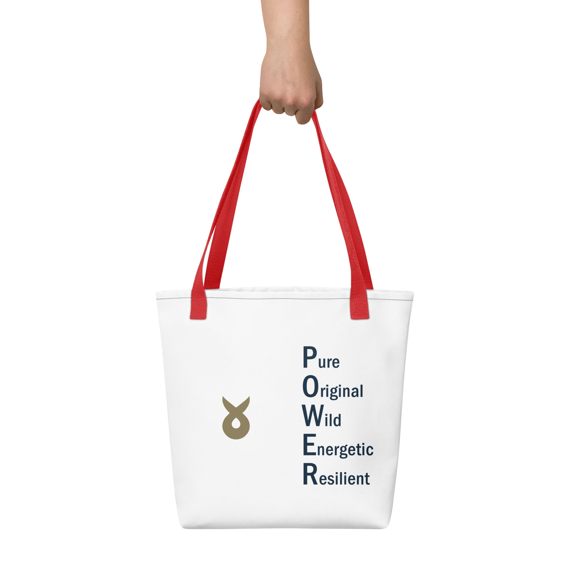 White tote bag with red handles, featuring the word "POWER" written vertically as an acronym (Pure, Original, Wild, Energetic, Resilient) and a gold Ballstad logo beside the text, held by a hand against a plain white background.
