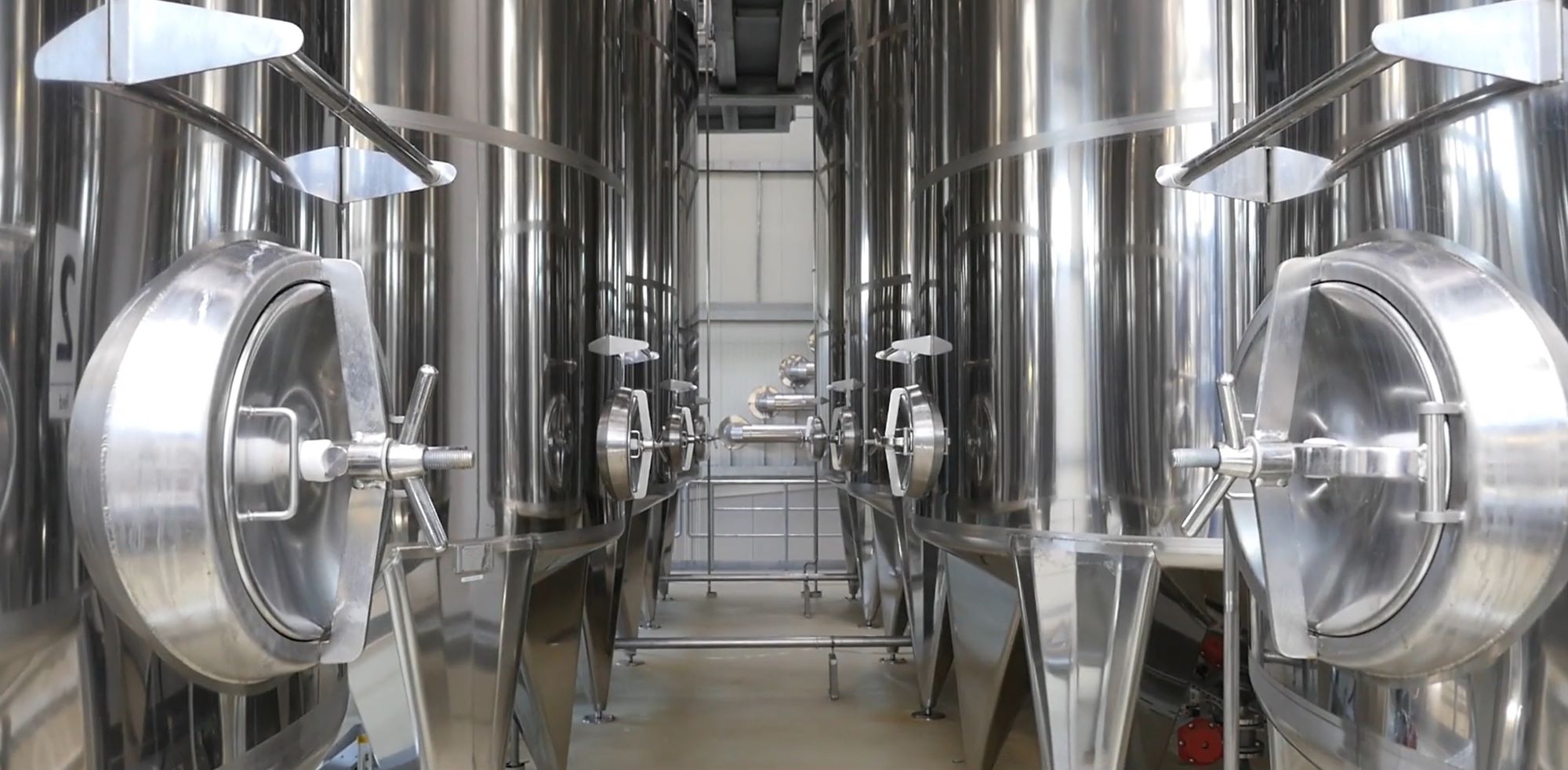 multiple big steel tanks next to each other in a clean industrial environment