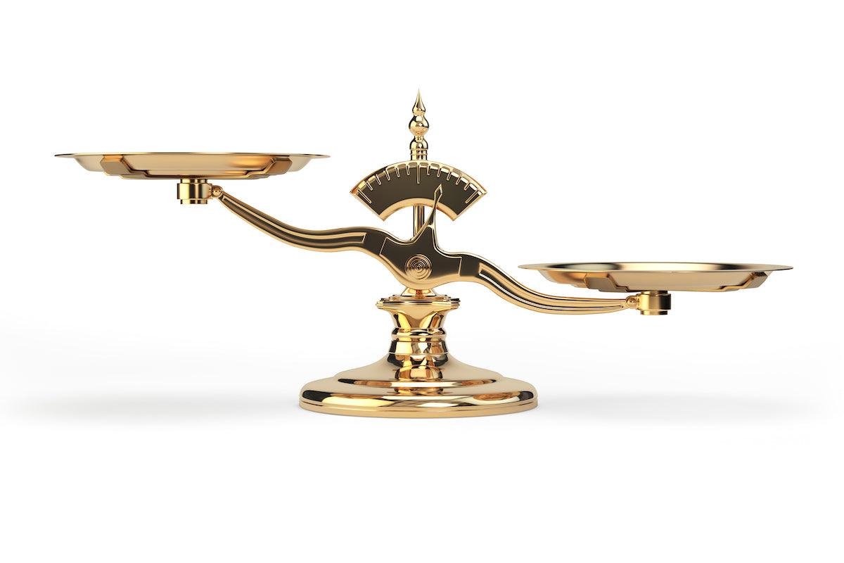 A shiny golden balance scale with empty trays on both sides, set against a white background, symbolizing equality and measurement.