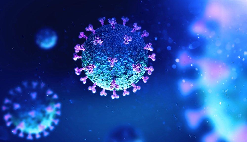 Digital illustration of a coronavirus particle, depicted in blue with purple spike proteins, set against a dark blue abstract background with a glowing light effect.