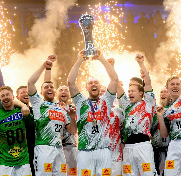 SC Magdeburg handball team celebrating championship victory with trophy and fireworks — elite performance, team spirit, and European handball success